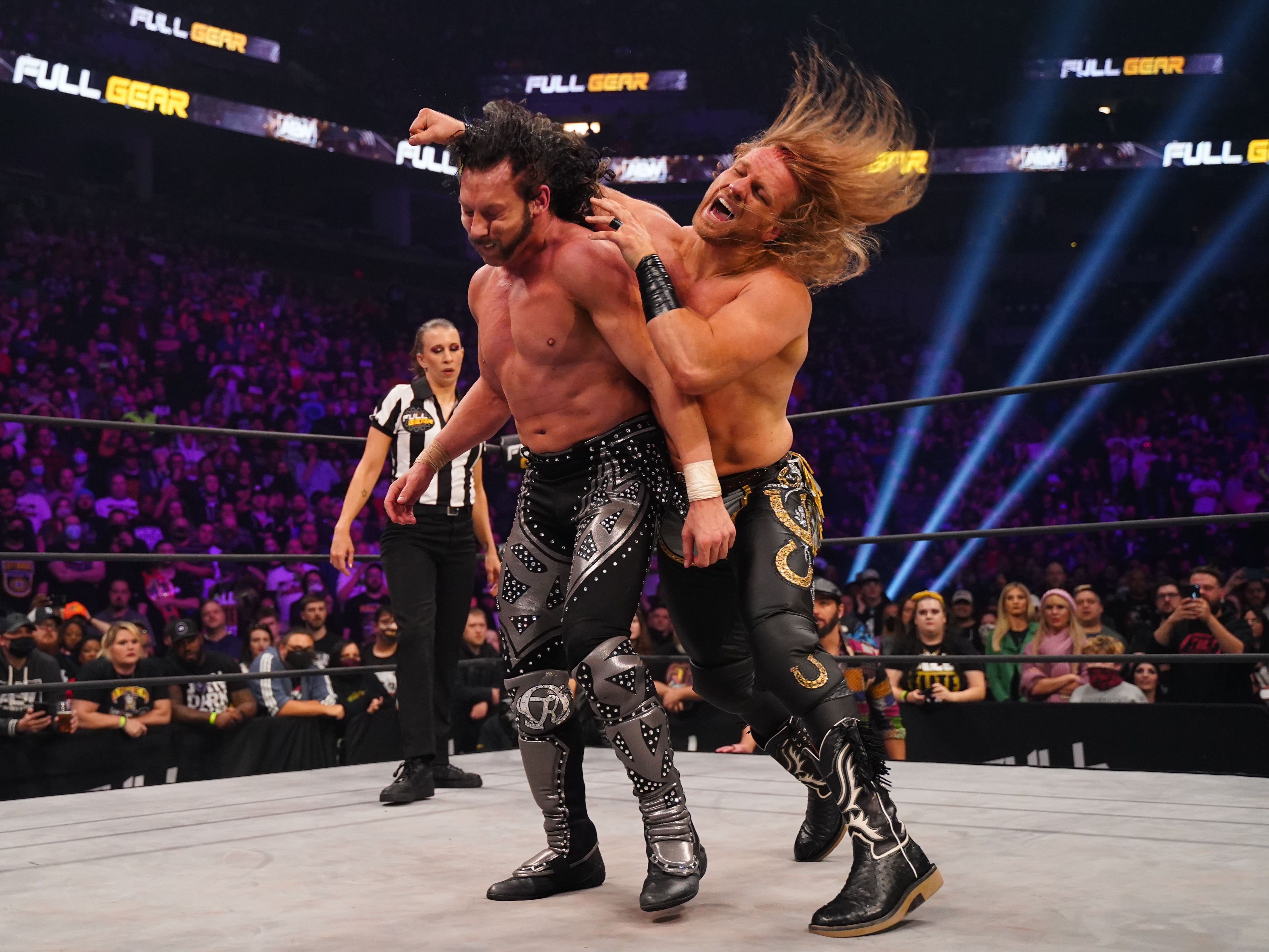 Hangman Page delivers a blow to Kenny Omega.